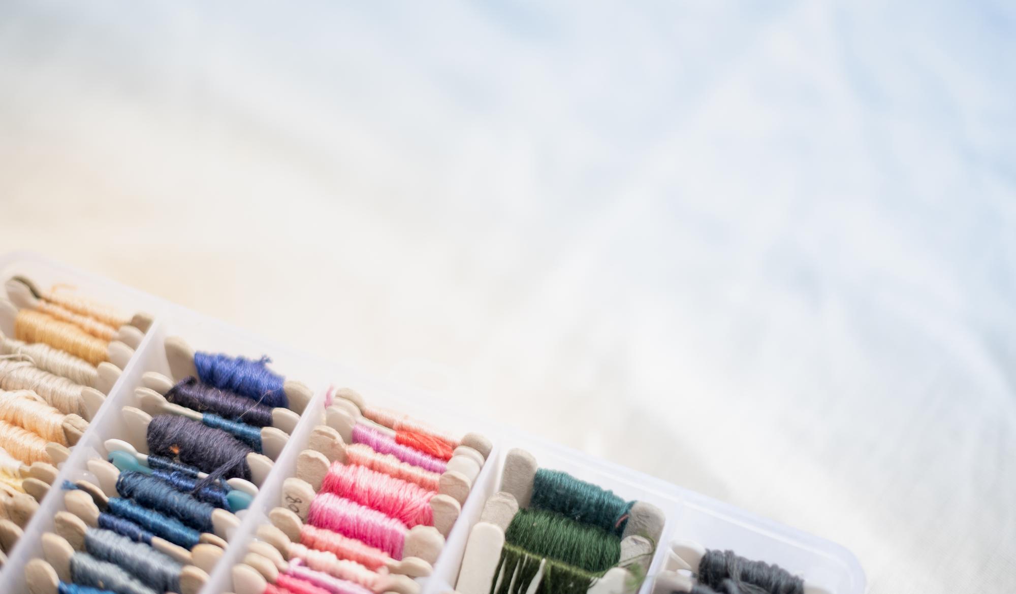 Sample swatches and thread cards on table